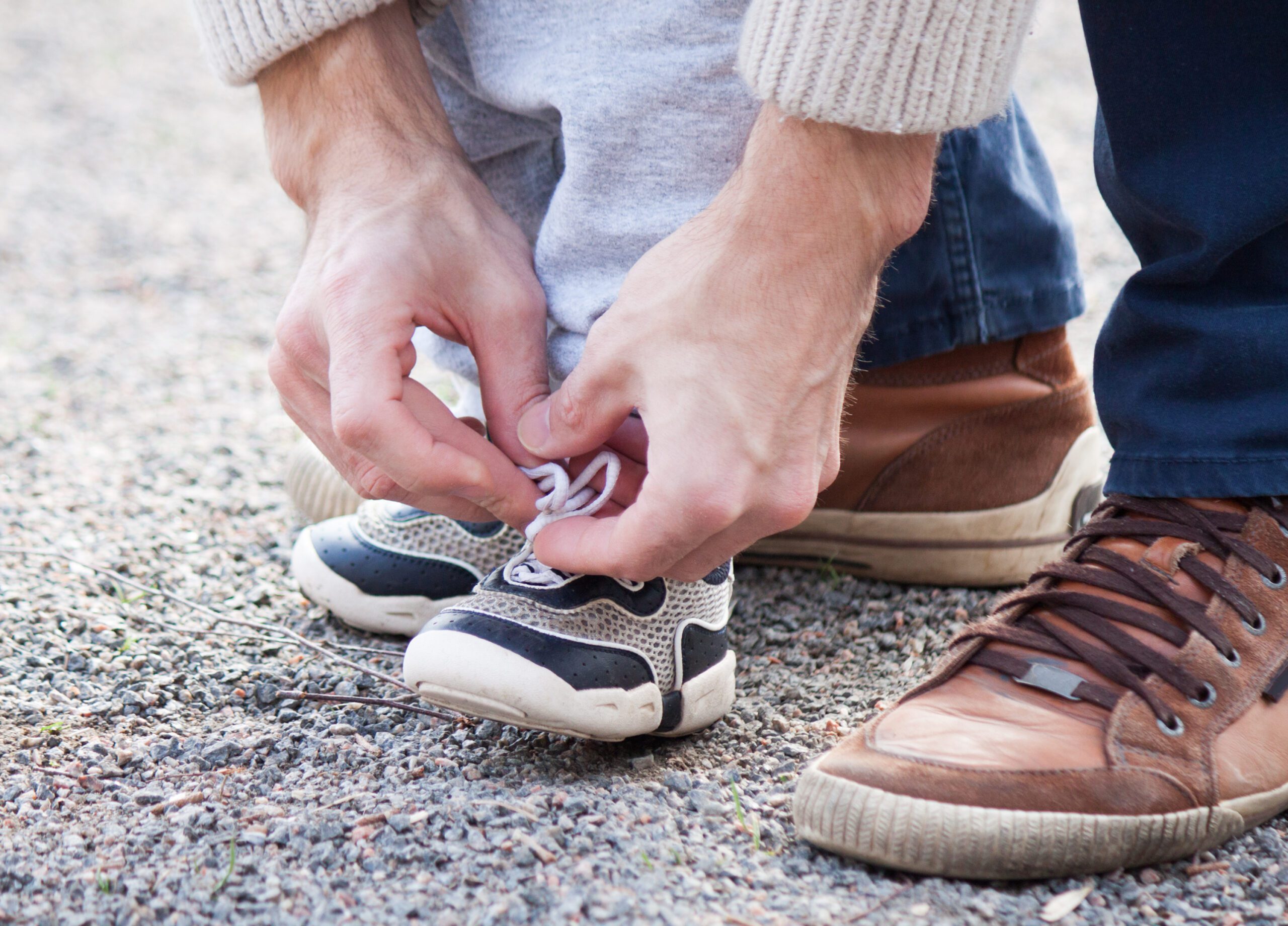 Adult tying childs shoe lace