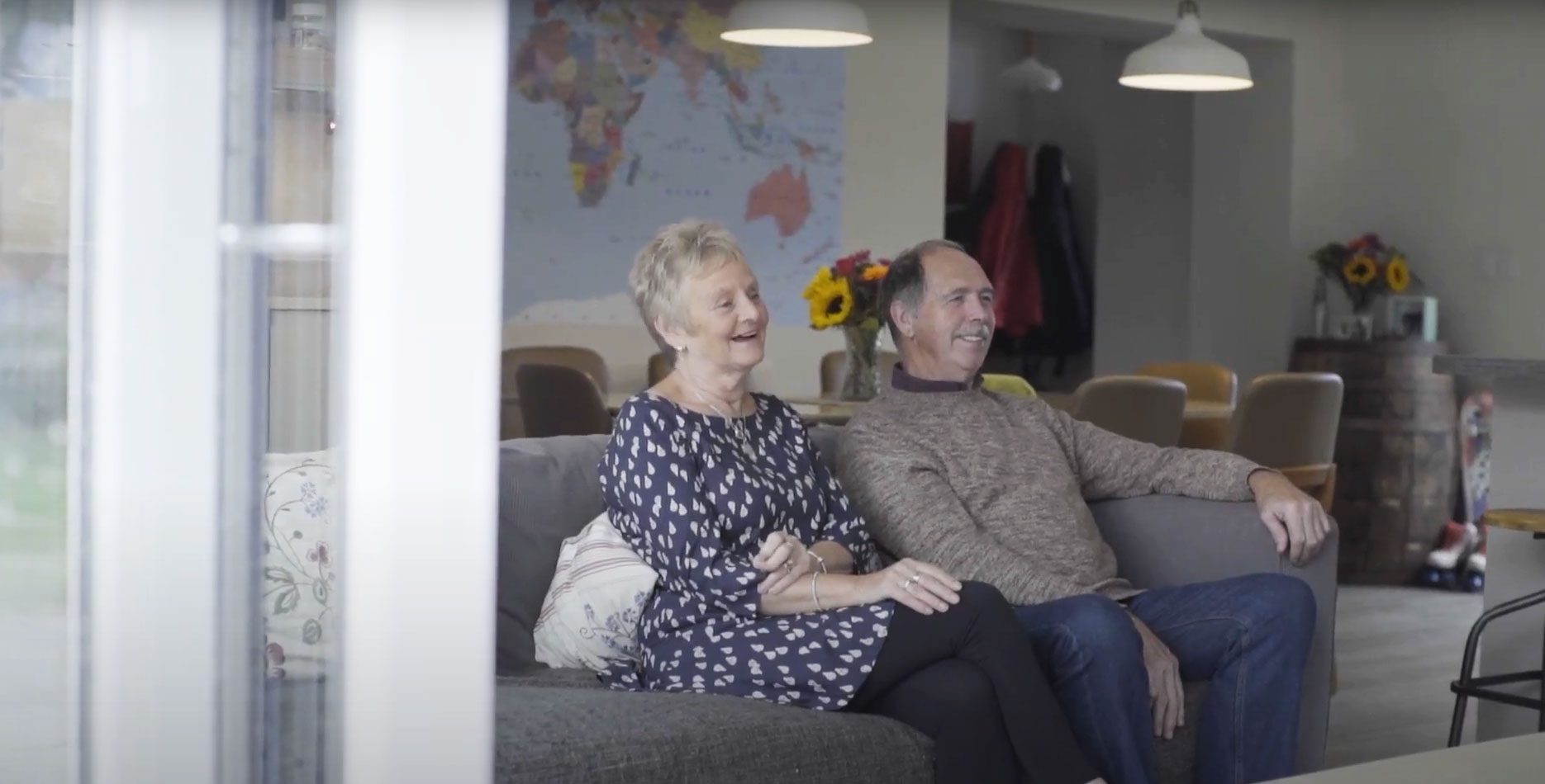 Linda and Pete elderly foster carers sat on the sofa