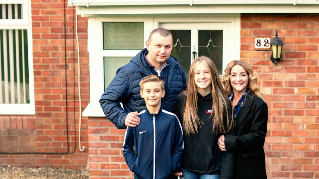 Foster Family photo outside residence