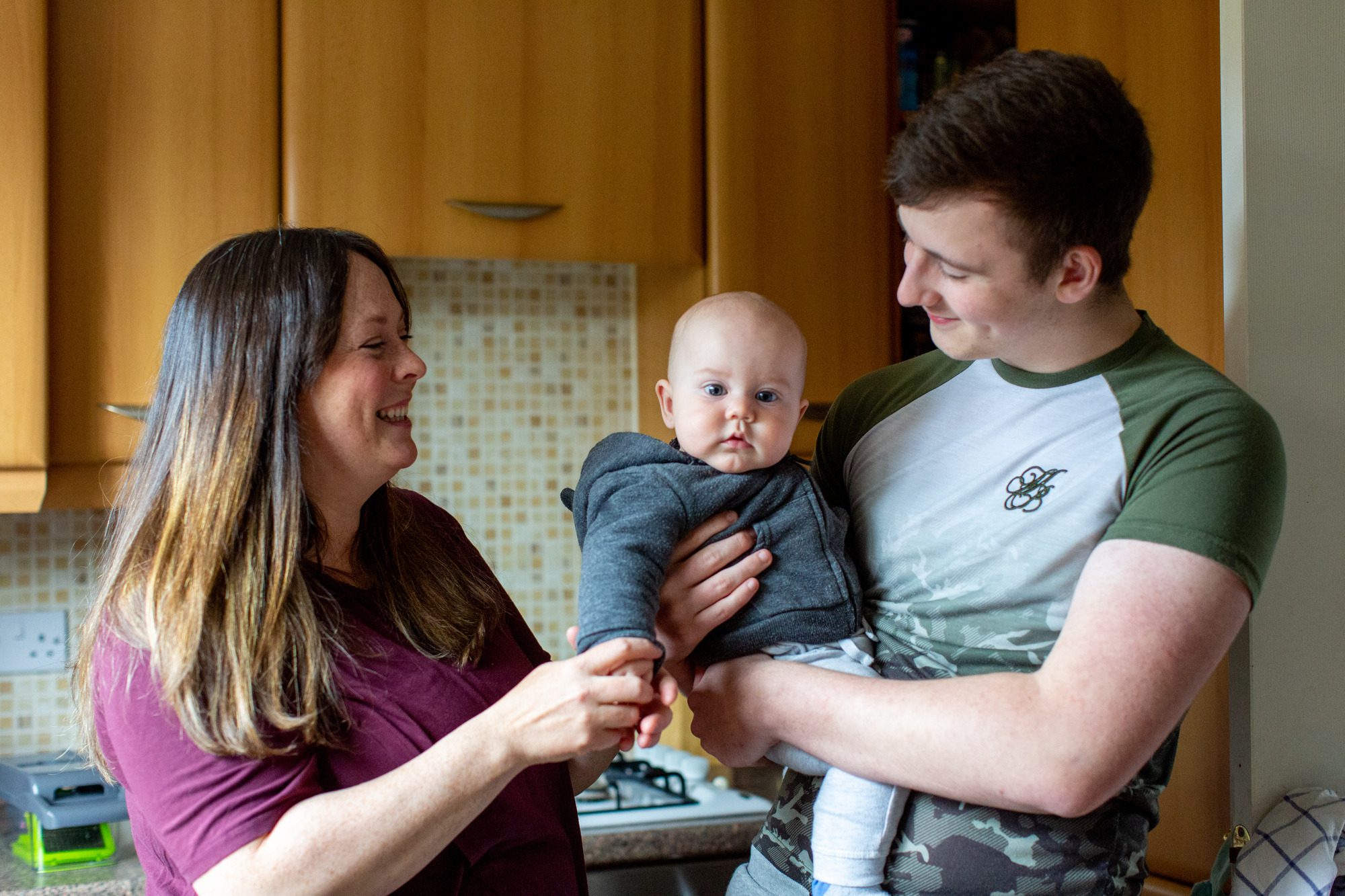Foster family smiling with a baby