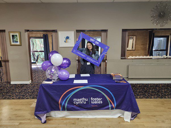 Foster Wales Caerphilly staff member holding a Foster Wales frame